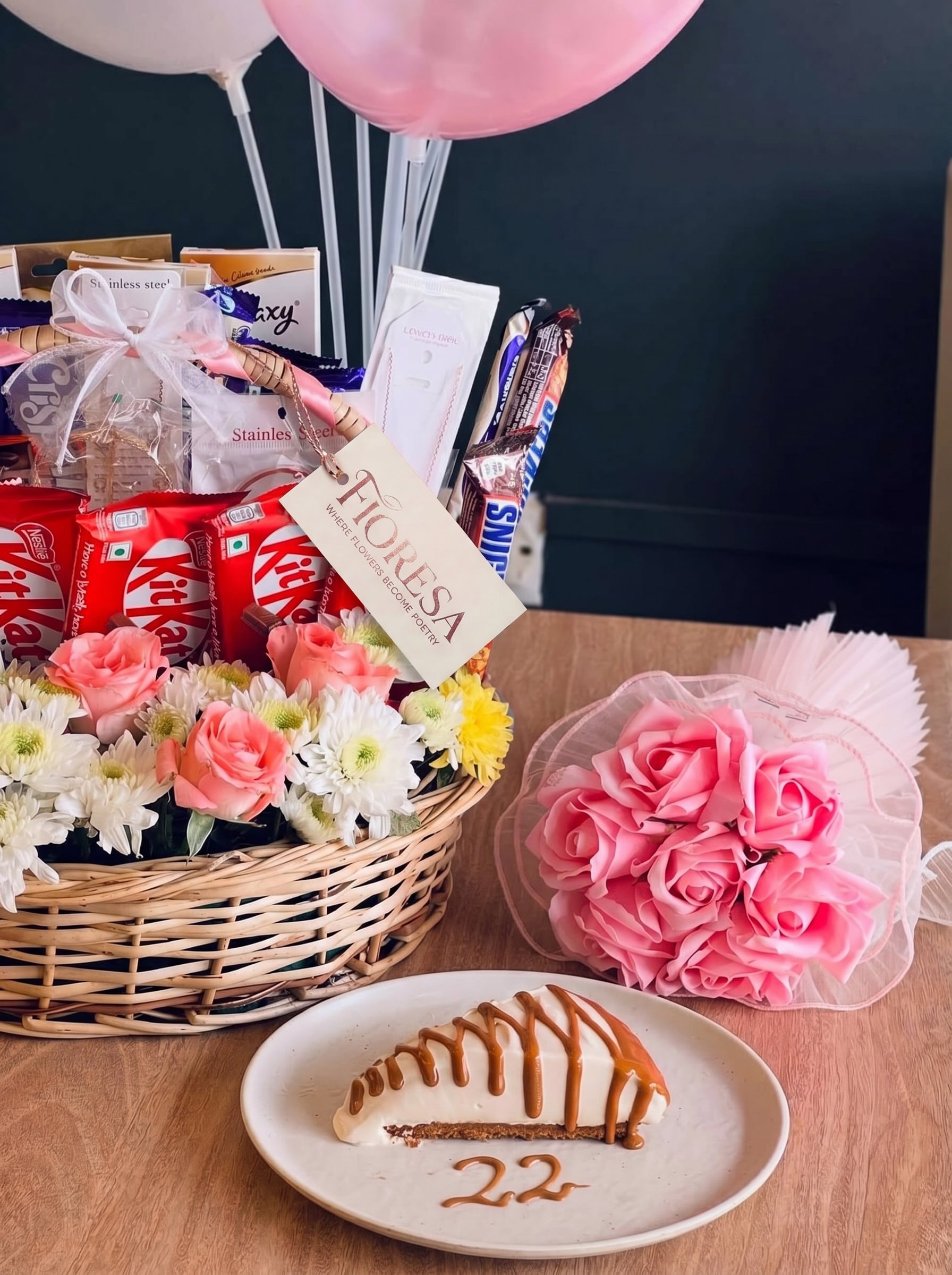A Fioresa gift basket next to a caramel cheesecake slice with twenty-two written below.